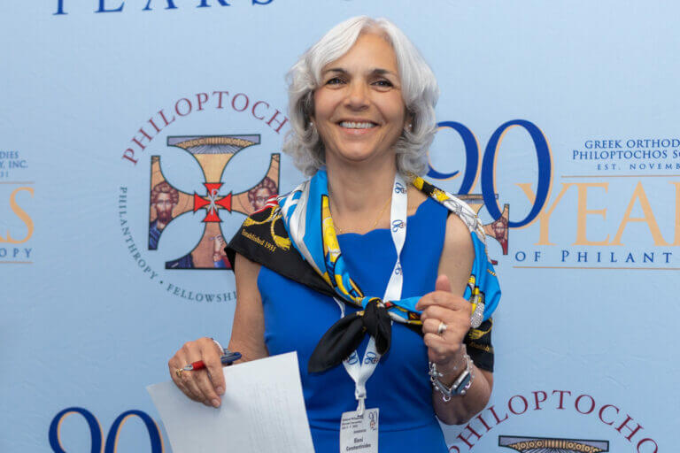 Woman holding an award at the 90th anniversary event