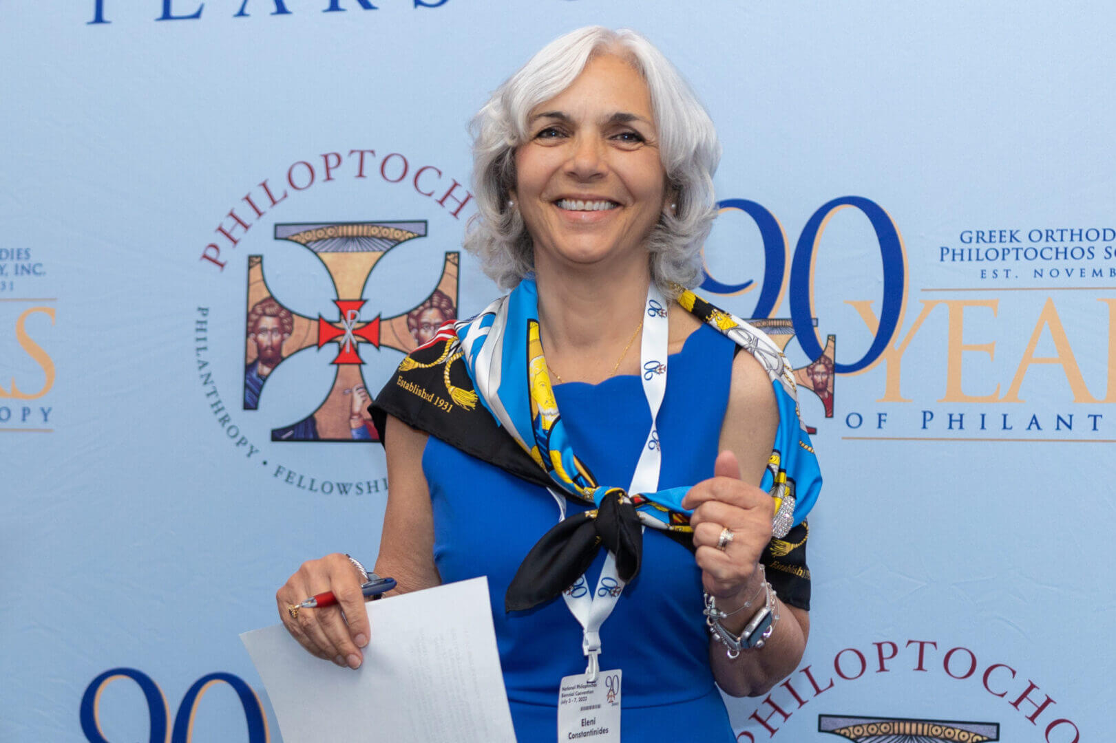 Woman holding an award at the 90th anniversary event