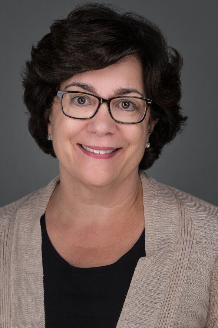 Woman with short dark hair and glasses, portrait