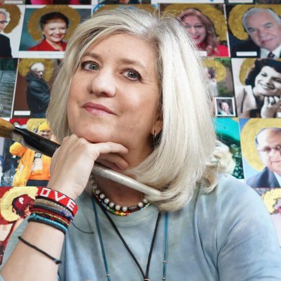 Woman with blonde hair resting her chin on her hand, larger